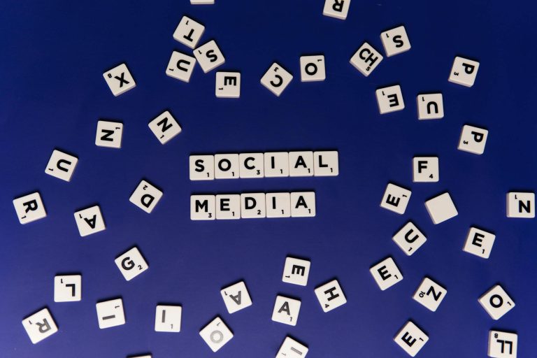The Essentials of Blogging: Tips and Strategies for Success 1 Scrabble tiles spelling 'Social Media' on a blue background, ideal for digital marketing themes.